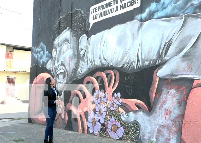 Muro con imagen de violencia hacia la mujer